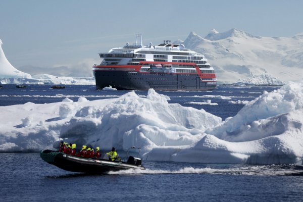Roald Amundsen in the background of the Zodiac in Antarctica MS Roald Amundsen please credit Hurtigruten