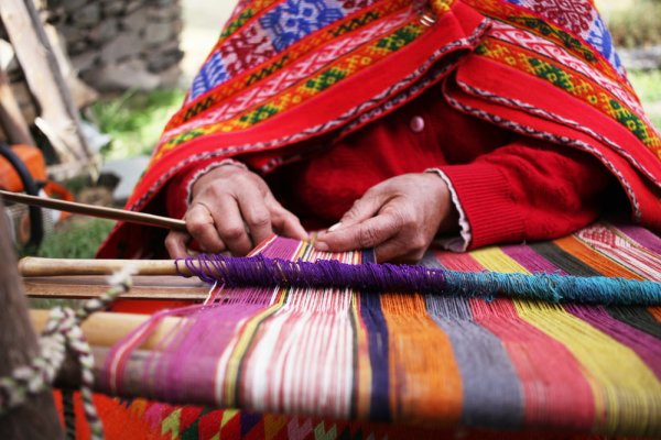 Peruvian woman making traditional clothes Peruvian woman making traditional clothes