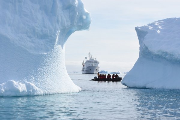 Cruise ship and a zodiac sailing between the glaciers Cruise ship and a zodiac sailing between the glaciers