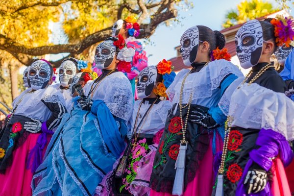 Group of women wearing traditional sugar skull masks and costumes Group of women wearing traditional sugar skull masks and costumes