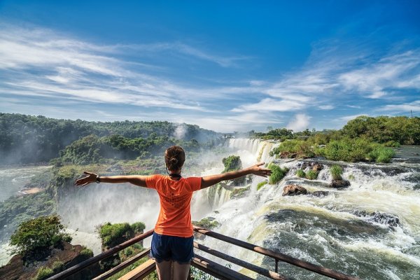 Tourist in Argentina on top of waterfall Tourist in Argentina on top of waterfall