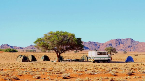 Group of tents and 4x4 offroad safari truck in Namibia Group of tents and 4x4 offroad safari truck in Namibia