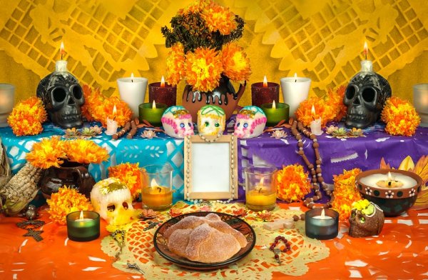 Traditional Mexican Day of the Dead altar with sugar skulls and candles Traditional Mexican Day of the Dead altar with sugar skulls and candles